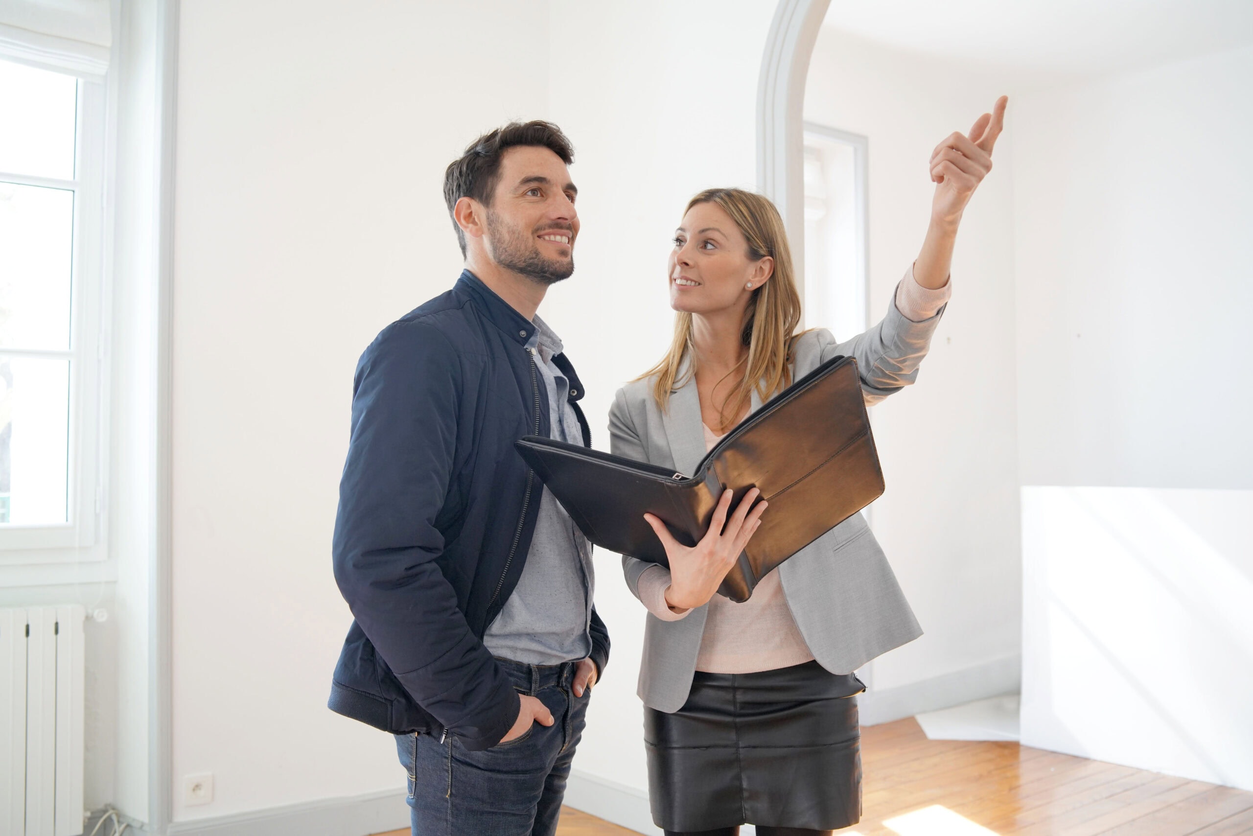 An estate agent shows a man around a house
