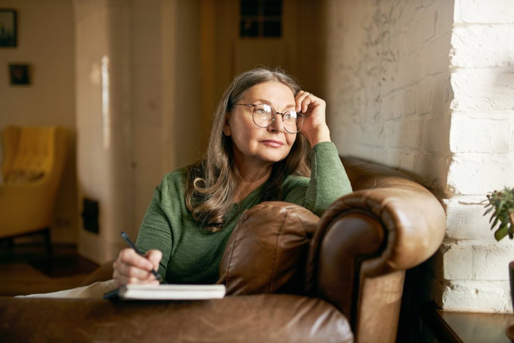 A woman thinks through her options while considering whether to refinance her home loan.