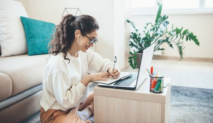 Woman taking an online course in living room