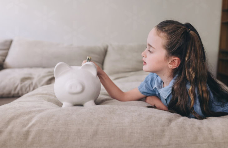 young girl with her piggy bank